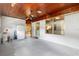 Spacious garage featuring painted block walls, ample lighting, a window, and a retro paneled ceiling at 220 N Julia Ave, Deland, FL 32720