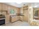 Cozy kitchen with tile flooring, matching cabinets, a stainless steel oven, and ample natural light at 220 N Julia Ave, Deland, FL 32720