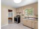 Cozy kitchen with tile flooring, matching cabinets, a stainless steel oven, and ample natural light at 220 N Julia Ave, Deland, FL 32720