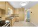 Cozy kitchen with tile flooring, matching cabinets, a stainless steel oven, and ample natural light at 220 N Julia Ave, Deland, FL 32720