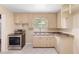 Cozy kitchen with tile flooring, matching cabinets, a stainless steel oven, and ample natural light at 220 N Julia Ave, Deland, FL 32720
