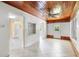 Bright living room featuring a wooden ceiling, white brick walls, and tile flooring at 220 N Julia Ave, Deland, FL 32720