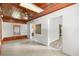 Bright living room featuring a wooden ceiling, white brick walls, and tile flooring at 220 N Julia Ave, Deland, FL 32720