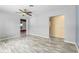 Open-concept living room with gray walls, wood-look floors, and views to the kitchen at 220 N Julia Ave, Deland, FL 32720