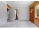 Spacious sunroom with painted block walls and carpet flooring, offering potential for versatile use and additional living space at 220 N Julia Ave, Deland, FL 32720