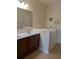 Well-lit bathroom with a double vanity, and a step-in tub for accessibility at 223 W Fiesta Key Loop, Deland, FL 32720