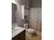 A full bathroom features a vanity with a mirror and a cabinet above the toilet at 223 W Fiesta Key Loop, Deland, FL 32720