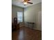 This bedroom features hardwood floors, a ceiling fan and a window with blinds at 223 W Fiesta Key Loop, Deland, FL 32720