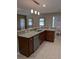 Granite countertops accent cherry cabinets in this bright eat-in kitchen with tiled flooring at 223 W Fiesta Key Loop, Deland, FL 32720