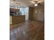 Open-concept living space with modern laminate flooring flowing into the kitchen and dining area at 223 W Fiesta Key Loop, Deland, FL 32720