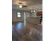 Bright and airy living area with laminate flooring, leading to the kitchen and a sliding glass door at 223 W Fiesta Key Loop, Deland, FL 32720