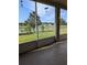 View from screened in porch overlooking landscaped backyard and pond at 223 W Fiesta Key Loop, Deland, FL 32720