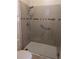 Modern tiled shower features glass doors, grab bar, and handheld shower head at 223 W Fiesta Key Loop, Deland, FL 32720