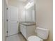 Bright bathroom featuring a large mirror, sink, vanity, and toilet at 2241 Litchfield Loop, Deland, FL 32720