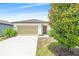 Charming single-story home featuring a two-car garage, well-manicured lawn, and inviting curb appeal at 2241 Litchfield Loop, Deland, FL 32720