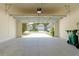 Spacious garage interior showing the driveway and homes across the street at 2241 Litchfield Loop, Deland, FL 32720
