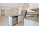 Bright kitchen with white cabinetry, stainless steel appliances, and granite countertops, open to the living area at 2241 Litchfield Loop, Deland, FL 32720