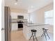 Open kitchen featuring granite counters, stainless steel appliances, and a breakfast bar with seating at 2241 Litchfield Loop, Deland, FL 32720