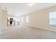 Inviting living space showcasing carpet floors and natural light from windows, adjacent to a kitchen at 2241 Litchfield Loop, Deland, FL 32720
