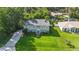 Aerial view of a home situated on a lush green lawn with mature trees and a long driveway at 2250 Davis Dr, New Smyrna Beach, FL 32168