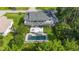 Aerial view of a home with an in-ground pool, patio, and balcony overlooking a lush, green backyard at 2250 Davis Dr, New Smyrna Beach, FL 32168