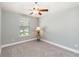 Cozy bedroom with neutral carpet, ceiling fan, and a window with natural light at 2250 Davis Dr, New Smyrna Beach, FL 32168
