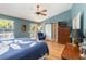 Spacious primary bedroom featuring a ceiling fan, sliding barn door, and a balcony access at 2250 Davis Dr, New Smyrna Beach, FL 32168