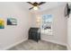Minimalist bedroom with ceiling fan and a window with natural light and view at 2250 Davis Dr, New Smyrna Beach, FL 32168
