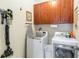 Functional laundry room with updated appliances, custom cabinets, and a convenient ironing station at 2250 Davis Dr, New Smyrna Beach, FL 32168