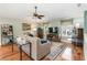 Comfortable living room showcasing hardwood floors, a ceiling fan, and natural light at 2250 Davis Dr, New Smyrna Beach, FL 32168