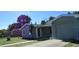 Charming single-story home featuring attached garage, front yard and mature trees at 2366 Florida Dr, Deltona, FL 32738