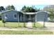 A gray house behind a gray chainlink fence on a sunny day at 2366 Florida Dr, Deltona, FL 32738