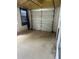 An empty single car garage with a concrete floor, window, and sectional garage door at 2366 Florida Dr, Deltona, FL 32738