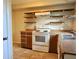 Traditional kitchen featuring white stove, open shelving, and wood cabinets at 2366 Florida Dr, Deltona, FL 32738