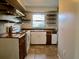 Kitchen with tile floor, shelving, and white cabinets at 2366 Florida Dr, Deltona, FL 32738