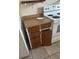 Cabinets with dark wood doors and a laminate countertop are next to a white range at 2366 Florida Dr, Deltona, FL 32738