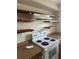 Traditional kitchen featuring white stove, open shelving, and light brown counters at 2366 Florida Dr, Deltona, FL 32738