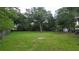 Expansive backyard with mature trees, offering privacy and a serene outdoor space at 2380 Spring Hollow Drive, Orange City, FL 32763