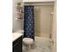 Cozy bathroom featuring a shower with blue pattern curtain, modern fixtures and stylish marble tile flooring at 2380 Spring Hollow Drive, Orange City, FL 32763