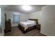 Inviting bedroom with wood-look floors, light bedding, and a dresser offers a comfortable and serene space at 2380 Spring Hollow Drive, Orange City, FL 32763