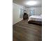 A comfortable bedroom features wood-look flooring, soft curtains, and a dresser, offering a peaceful escape at 2380 Spring Hollow Drive, Orange City, FL 32763
