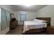 Relaxing bedroom featuring a wood-frame bed, light bedding, wood-look flooring, and soft, natural lighting at 2380 Spring Hollow Drive, Orange City, FL 32763