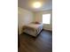 Cozy bedroom featuring modern flooring, a comfortable bed, and a bright window for natural light at 2380 Spring Hollow Drive, Orange City, FL 32763