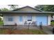 Charming single-story home with a light exterior, shutters, and a blue garage door at 2380 Spring Hollow Drive, Orange City, FL 32763