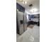 Modern kitchen with stainless steel appliances, dark cabinets, and stylish marble tile flooring at 2380 Spring Hollow Drive, Orange City, FL 32763