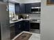 Well-appointed kitchen featuring stainless steel appliances, dark cabinetry, and sleek countertops at 2380 Spring Hollow Drive, Orange City, FL 32763
