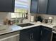 Beautiful kitchen with granite countertops and navy blue cabinets, a bright space to cook and entertain at 2380 Spring Hollow Drive, Orange City, FL 32763