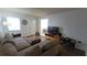 Comfortable living room with neutral tones, featuring a sectional sofa and laminate flooring at 2380 Spring Hollow Drive, Orange City, FL 32763