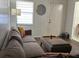 Bright living room with laminate flooring, neutral decor, and comfortable seating near a window at 2380 Spring Hollow Drive, Orange City, FL 32763