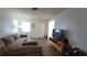 Inviting living room with natural light, featuring laminate flooring and a comfortable sectional sofa at 2380 Spring Hollow Drive, Orange City, FL 32763